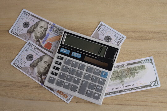 Top View of Calculator Placed on Hundred Dollar Bills