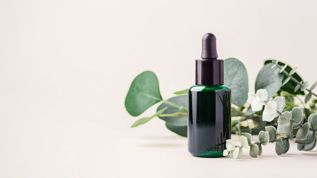 Essential oil dropper bottle with green leaves decoration