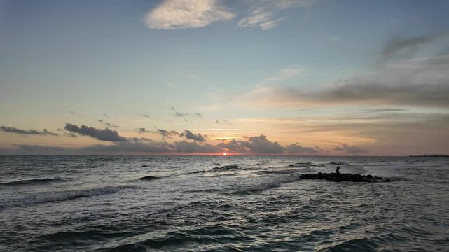 Dramatic evening sky, sea waves and warm sunset light create a scenic coastal atmosphere along the Tyrrhenian Sea.