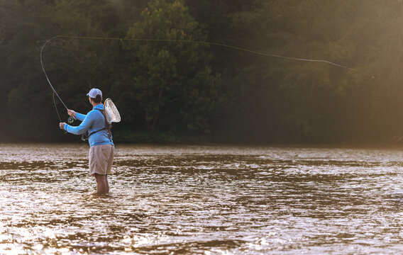 Man casting a line while fly fishing in a river
