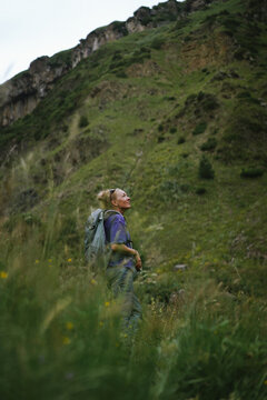 Woman hiker pauses to admire the mountain view