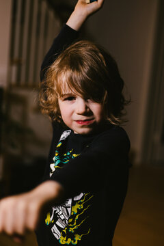 Fierce young boy playing and looking at camera