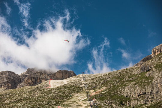 Lone paraglider soars over a mountain range