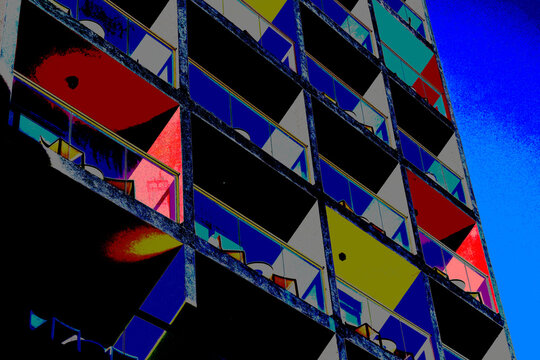 Colorful modern apartment building exterior with balconies and blue sky