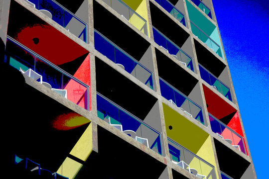 Colorful modern apartment building exterior with balconies and blue sky