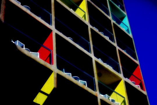 Colorful modern apartment building exterior with balconies and blue sky