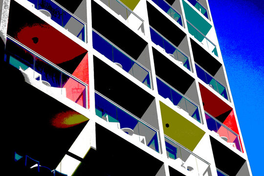Colorful modern apartment building exterior with balconies and blue sky