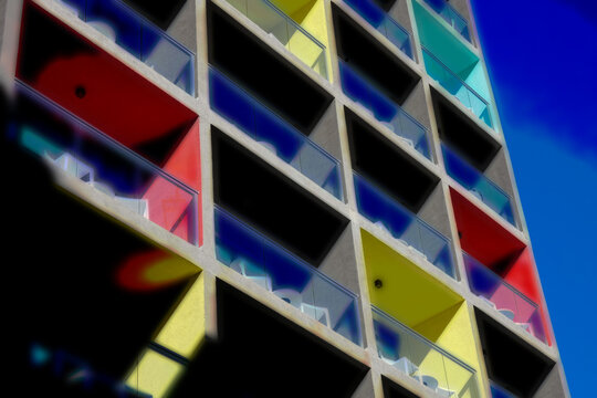 Colorful modern apartment building exterior with balconies and blue sky