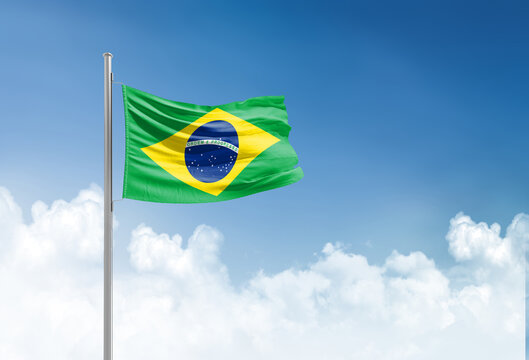 Brazil flag waving in beautiful sky.