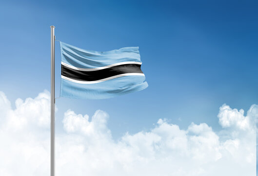 Botswana flag waving in beautiful sky.