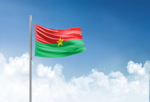 Burkina Faso flag waving in beautiful sky.