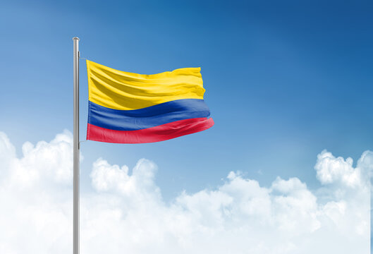 Colombia flag waving in beautiful sky.
