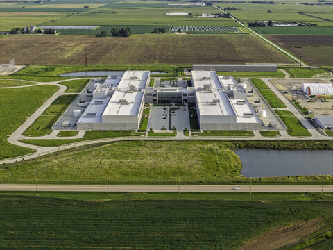 Aerial view of a large data center facility surrounded by expansive agricultural fields and rural landscape in DeKalb, Illinois, United States.