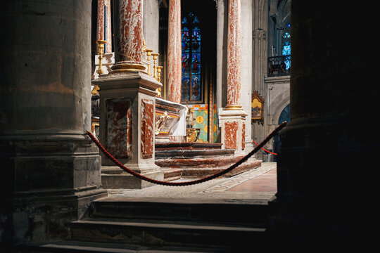 Ornate altar and marble columns inside a historic church