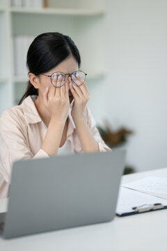 Eye problems, Asian women massage eye for relax, eye rubbing, dry, eye pain after work, migraine, headache, blurred vision, photophobia, working in the dark, blue light from computer screens