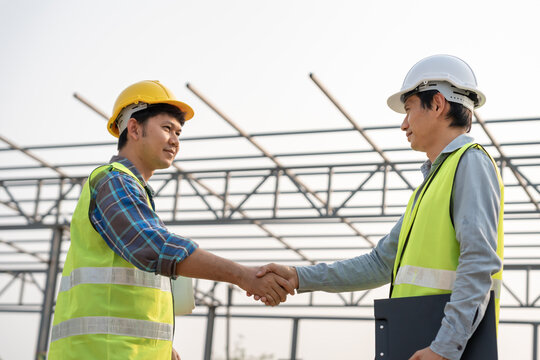 Construction team hands shaking greeting start up plan new project contract in office center at construction site, industry ,architecture, partner, teamwork, agreement, property, contacts.