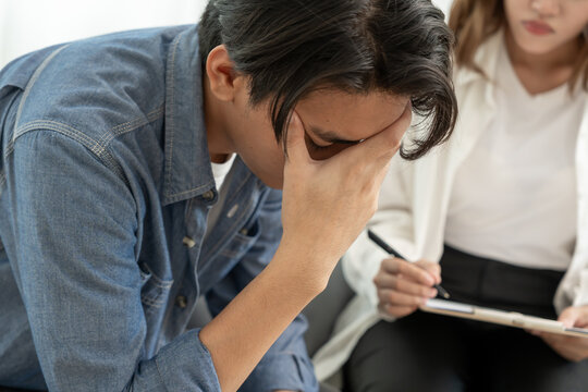 man cover face felling sad from health problems. psychiatrist is recording the patient's condition for treatment. encouragement, love and family problem, bipolar , depression patient, protect suicide