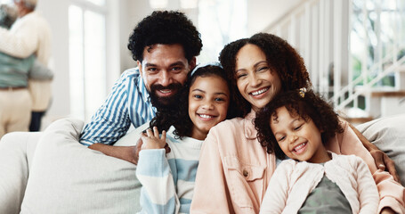 Obraz premium Portrait, parents and children in living room with smile, family and bonding together for wellness. Happy people, mother and father relax in home with girl kids, love and connection for good mood.