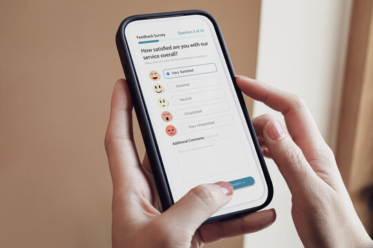 Close-up of woman hands holding smartphone filling online feedback survey and selecting Very Satisfied option. Concept of customer satisfaction, service evaluation, and experience rating.