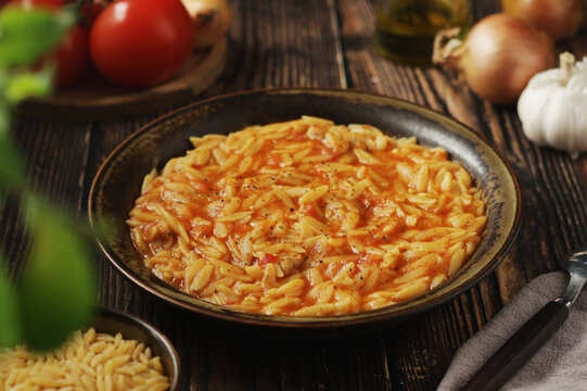 A bowl with traditional Greek soup Manestra with orzo pasta
