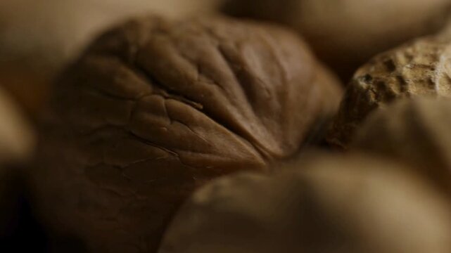 Extreme close up panning over walnut and peanut shells