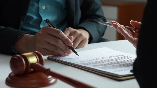 Lawyer advising client on signing legal contract document