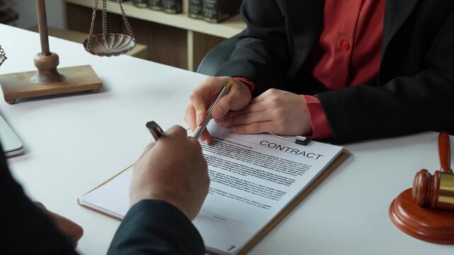 Lawyer advising client on legal contract before signing