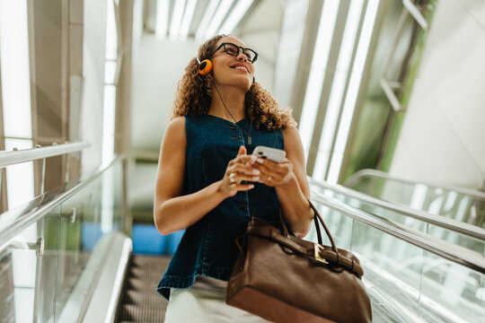 Listening to music on the escalator during city commute
