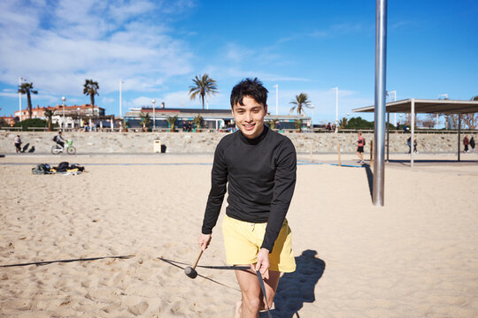 Young athlete playing diabolo during a friendly sports session on the waterfront
