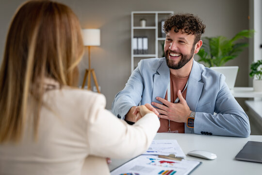 Business meeting in modern office with handshake between two professionals