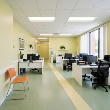 Bright modern office interior with desks and chairs in a healthcare administration setting