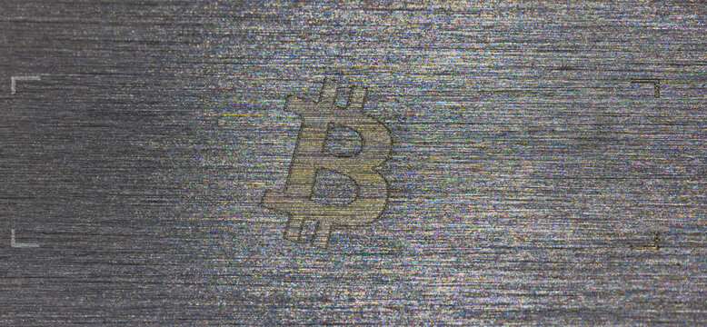 Bitcoin Symbol Etched on Brushed Metal Surface