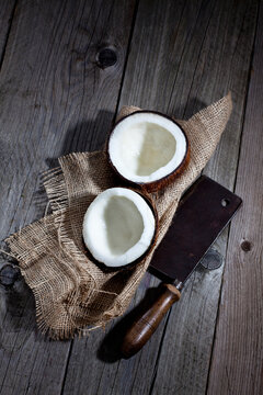 Split coconut on hessian and old cleaver