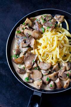 Champignons and king trumpet mushrooms in cream sauce with cheese stripes