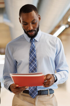 A businessman reads a document in a modern office