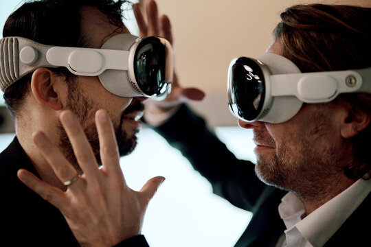 Businessman interacting with virtual reality headset in smart office
