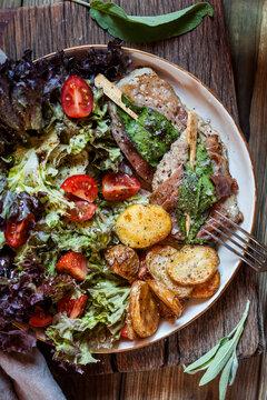 Saltimbocca alla Romana with salat and fried potatoes