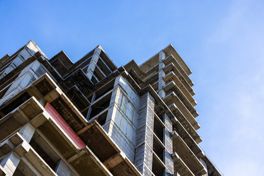 Unfinished Concrete Building Structure Against Blue Sky
