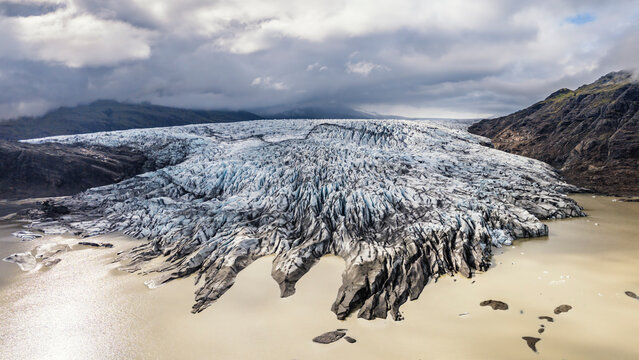 Aerial view of Fl�aj�kull Glacier meeting lagoon in Icelandic landscape