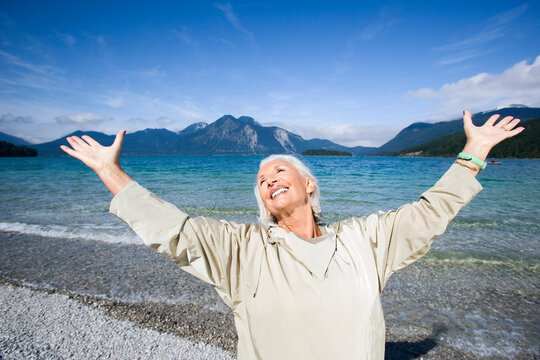 Germany, Bavaria, Walchensee, Senior woman, cheering