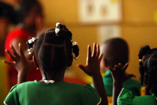 Dominica, Roseau, Preschool Social Center, rear portrait of girl with braids