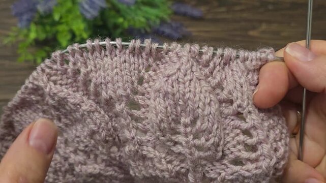 Multicolored hand-knitted fabric. Knitting and crochet lessons. Fashion and education. Training for artificial intelligence. Hands in the frame.