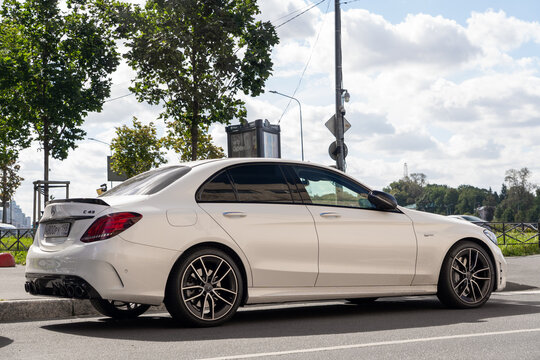 White luxury sport Mercedes-Benz C43 AMG W205 sedan car parked on an urban street side, exterior of premium high performance german vehicle, contemporary lifestyle city transport. German premium car.