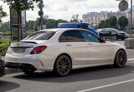 White luxury sport Mercedes-Benz C43 AMG W205 sedan car parked on an urban street side, exterior of premium high performance german vehicle, contemporary lifestyle city transport. German premium car.