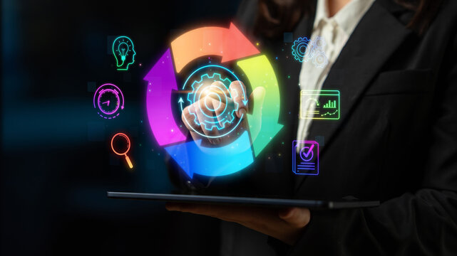 Business professional interacting with colorful digital interface featuring gears and icons representing data analysis and process optimization in a modern workplace Sigmoid