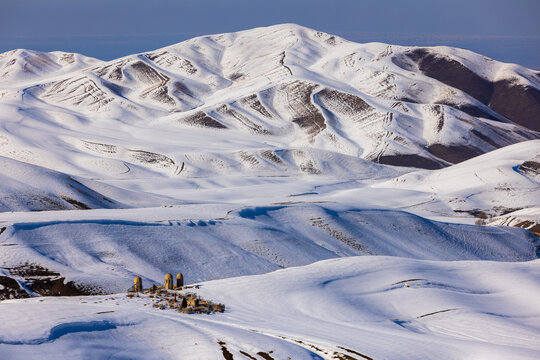 Aerial View of Snow-Covered Mountains and Muslim Cemetery in Kyrgyzstan