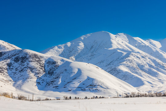 Majestic Snow-Covered Mountains Under Clear Blue Sky