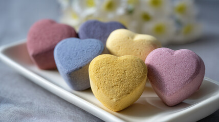 Obraz premium Heart shaped soap bars on tray with copy space, pastel wellness valentine gift, ceramic dish