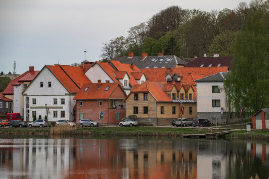 Traditional red tile roofs and wooden houses in the historic old town of Talsi, Latvia.