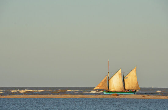 Madagascar, Morondava, Fisherman boat with large white sails at sea